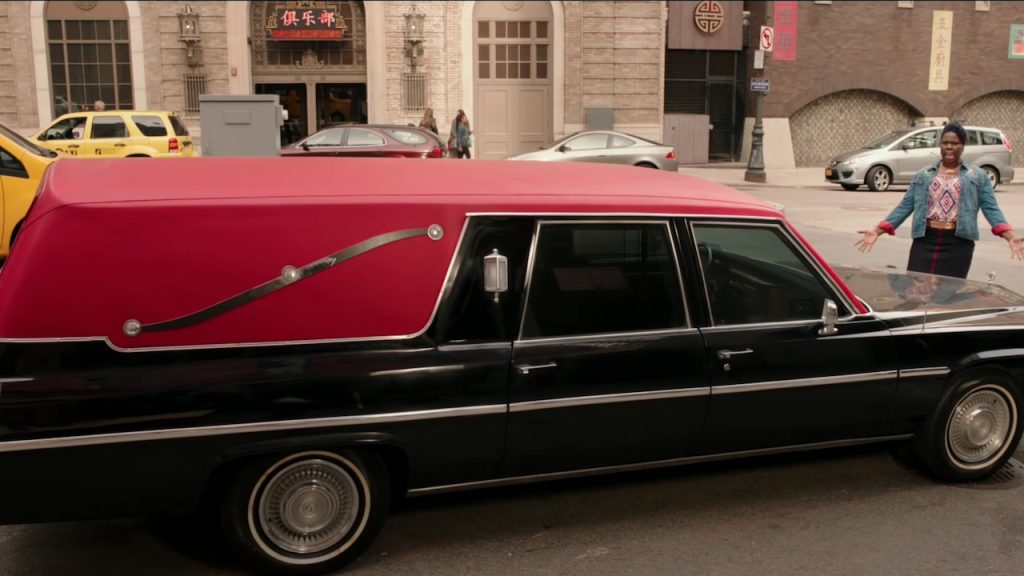 A shot of the ECTO-1 in the street at the Ghostbusters HQ in the 2016 movie
